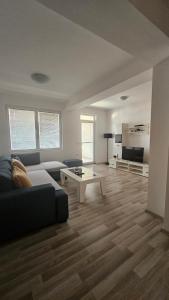 a living room with a couch and a table at Apartments LOTUS in Gevgelija