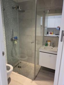 a bathroom with a shower and a toilet and a sink at Mon jardin secret in La Marsa +15 photos