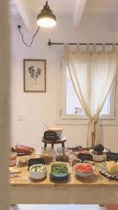 a table with many bowls of food on it at Hotel Casa Fiets in Alaior