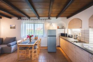 a kitchen with a table and a couch in a room at Bleicher Borbirtok in Balatonkeresztúr