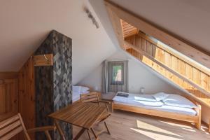 a bedroom with a bed and a desk and stairs at Bleicher Borbirtok in Balatonkeresztúr