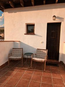 two chairs and a table on a porch at Casa Velez in Vélez de Benaudalla