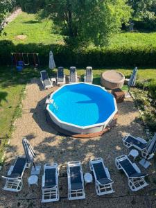 a group of chairs and a swimming pool and a group of chairs and a group at Къща за гости Крапец in Krapets
