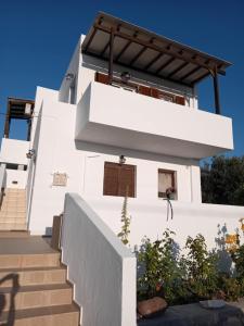 a white house with stairs in front of it at Nota's House in Adamantas +11 photos