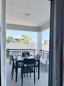 a dining room with a table and chairs on a balcony at Bountiful Estates Fantasy in Nadi
