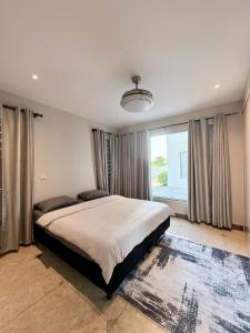 a bedroom with a large bed and a large window at Bountiful Estates Fantasy in Nadi +17 photos