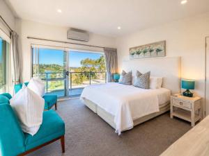 a bedroom with a bed and a large window at Bella Seven- Stay Waiheke in Oneroa +17 photos