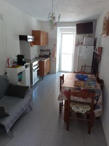 a living room with a table and a kitchen at Casa vacanze nel Parco della Majella in Montenerodomo