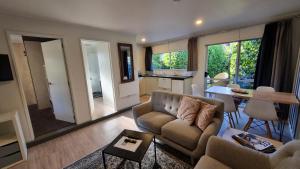 a living room with a couch and a table at Peak Sport Chalet in Wanaka
