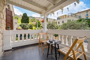 a balcony with chairs and a table with a view at City Port Hotel by Sea N Rent in Haifa
