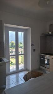 a kitchen with an open door to a balcony at Appartamento Rubiana in Rubiana