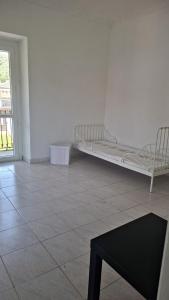 a room with two beds and a tiled floor at Appartamento Rubiana in Rubiana