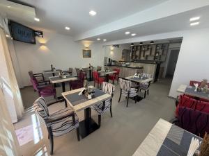 a dining room with tables and chairs in a restaurant at HOTEL PERLA - Free Parking in Sarajevo