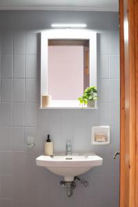 a bathroom with a white sink and a mirror at Ser Rooms 05 in Petra +11 photos
