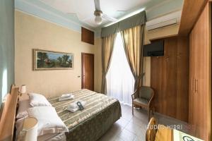 a hotel room with a bed and a window at Hotel Teti in Rome +73 photos