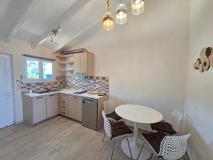 a kitchen with a table and a table and chairs at Coco's Corfu Apartments in Ipsos