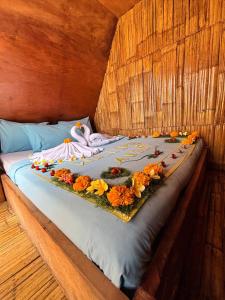 a bed with a bunch of flowers on it at Wanagiri Campsite in Gitgit