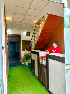 a man standing at a counter in a building at vista home stay in Lucknow