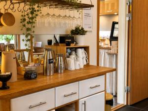 a kitchen with a counter with glasses on the wall at Rum För Resande in Skellefteå +12 photos