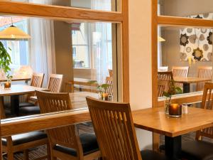 a dining room with wooden tables and chairs at Rum För Resande in Skellefteå