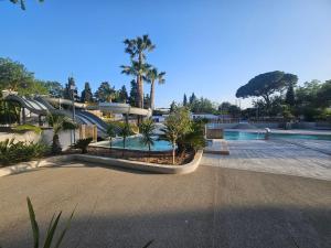 a water park with a slide and a swimming pool at camping des 7 fonts in Agde