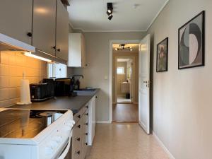 a kitchen with a sink and a counter top at Charming apartment with free parking close to Ålesund center in Ålesund