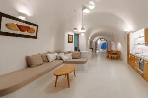 a living room with a couch and a table at EG Cave Houses in Éxo Goniá