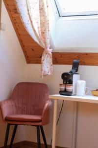a chair sitting next to a table with a skylight at B&B Adem in Horebeke