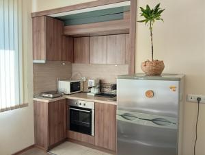 a small kitchen with a stainless steel refrigerator at Grand Central Varna in Varna City +40 photos