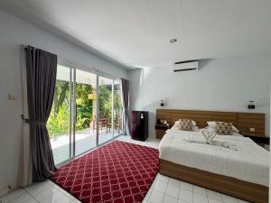 a bedroom with a large bed and a large window at New Mekar Jaya Hotel in Legian +72 photos
