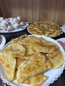a white plate of food on a table with pastries at Central Asia in Bukhara +22 photos