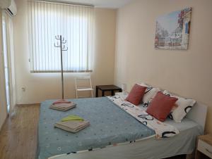 a bedroom with a large bed with pillows on it at Grand Central Varna in Varna City