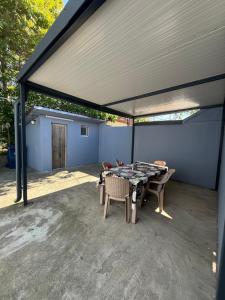 a covered patio with a table and chairs at Casa Bianca in Eforie Nord