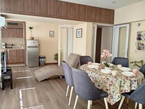 a dining room with a table and chairs at Grand Central Varna in Varna City