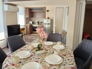 a dining room with a table with plates and chairs at Grand Central Varna in Varna City