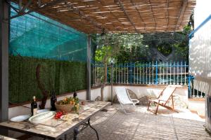 a patio with a table and chairs and a fence at La Polesana in Sorrento