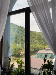 a window with a view of a roof at Aura in Dzerzhinskoye