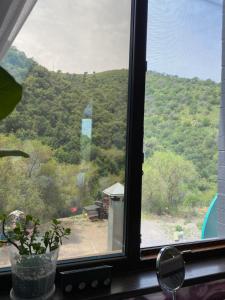 a window with a view of a mountain at Aura in Dzerzhinskoye +6 photos