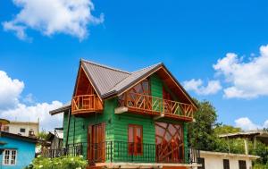 a green house with a metal roof at The Cloud-Line Cabana in Nuwara Eliya