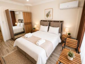a bedroom with a large bed and a mirror at Villa Incir in Kuşadası
