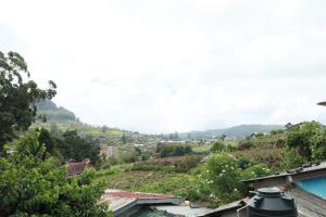 a view of a city with mountains in the background at The Cloud-Line Cabana in Nuwara Eliya +7 photos