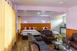 a hotel room with two beds and a couch at Hotel Monalisa Chitwan in Chitwan +8 photos