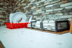 a table with plates and glasses and a red basket at Marionel Hôtel in Ampilahoa +126 photos