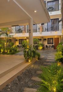 an empty courtyard of a building with plants at Red Coco Inn de Boracay in Boracay