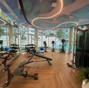 a gym with several exercise equipment in a building at Phyll Condo Room in Wichit in Ban Rangeng
