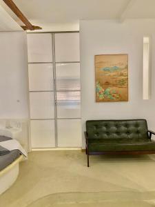 a living room with a green couch in a room at Siquijor Jade ocean resort in Siquijor +25 photos