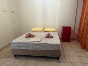 a bed in a room with two pillows on it at The salty studio in Rethymno +2 photos