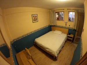 a small bedroom with a bed and a window at Colonia Real in Sucre