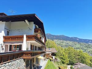 a building with wooden balconies on the side of it at Rundblick Gästehaus Schruns Tschagguns by Alpenfeder in Schruns
