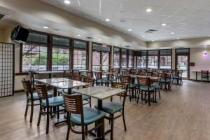 a dining room with tables and chairs and windows at Best Western Sunridge Inn & Conference Center in Baker City